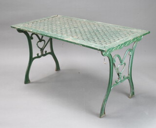A rectangular green painted aluminium and wooden garden table on shaped supports 64cm h x 118cm l x 64cm w  