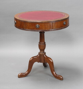 A Georgian style circular mahogany drum table with red leather surface, fitted 2 frieze drawers and raised on turned pillar and tripod supports 69cm h x 61cm diam. (some scuffing and marks to the top) 