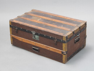A Victorian wooden and metal bound trunk, the interior lid labelled Halls Derby, with iron drop handles 32cm h x 78cm w x 45cm d 