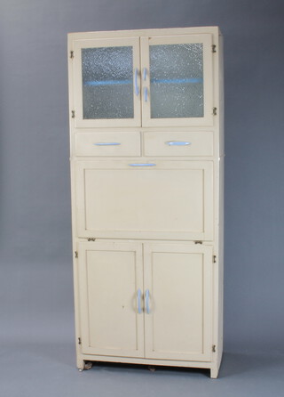 A 1930/40's white painted kitchen cabinet, upper section enclosed by frosted glass panelled doors above 2 short drawers with fall front, the base enclosed by a pair of panelled doors 180cm h x 77cm w x 38cm d (the blue plastic handle to the right hand door is damaged)