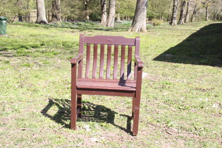 A brown painted slatted hardwood garden chair 87cm h x 63cm w x 54cm 