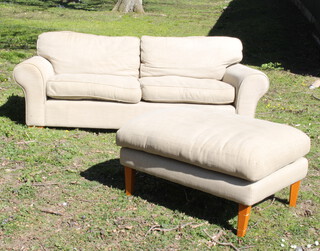 A 2 seat sofa upholstered in light material 76cm h x  217cm w x 100cm d together with a matching footstool 43cm h x 87cm w x 72cm d 