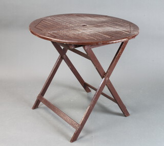 A brown painted circular hardwood slatted folding garden table 79cm h x 80cm diam. 