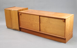 A mid Century teak record cabinet enclosed by panelled doors 59cm h x 51cm w x 42cm d and 1 other teak cabinet enclosed by sliding doors 54cm h x 128cm w (some contact marks in places) 