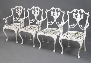 A set of 4 Victorian style white painted pierced aluminium garden armchairs with rose decoration 