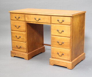 A beech finished pedestal desk/dressing table fitted 1 long and 8 short drawers on a platform base 77cm h x 109cm w x 50cm d (this is one section) 