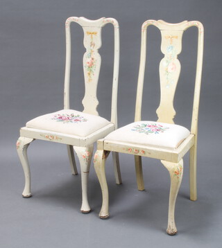 A pair of 1950's Queen Anne style white and floral painted slat back dining chairs with Berlin woolwork drop in seats, on cabriole supports (frames loose and paint loss in places) 