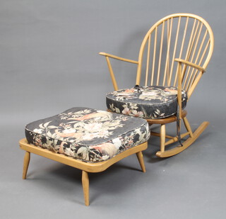 An Ercol mid Century beech and elm stick back rocking chair with Ercol label to the back together with a matching footstool (no label) 
