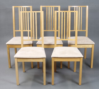 A set of 5 Ikea oak stick and bar back dining chairs, the seats upholstered in cream material (some stains to the seats)  