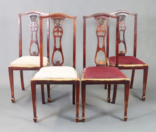 A set of 4 Edwardian carved and pierced mahogany slat back dining chairs with upholstered drop in seats 