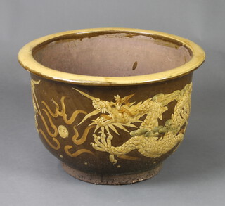 A circular Chinese style brown glazed terracotta plant pot 34cm h x 49cm diam. 