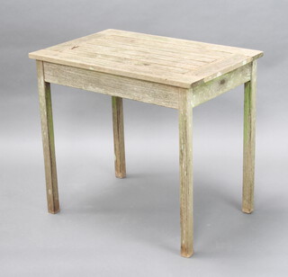A rectangular well weathered hardwood garden table 68cm x 76cm x 50cm 