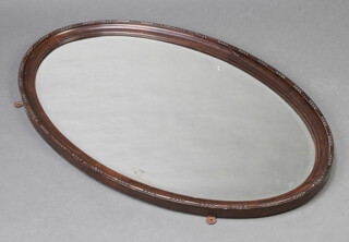 A 1930's oval bevelled plate wall mirror contained in a mahogany frame 58cm h x 90cm 