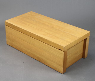 A light oak finished coffer enclosed by a sliding lid 30cm h x 84cm w x 42cm d