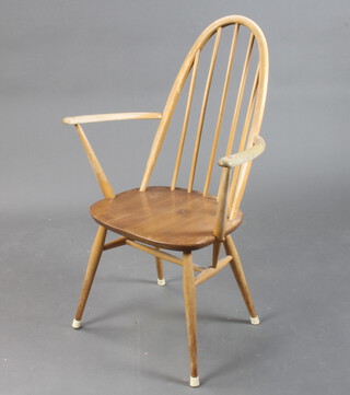 A mid Century Ercol light elm and beech stick and rail back carver chair with Ercol label to the back (arms require a repolish)  