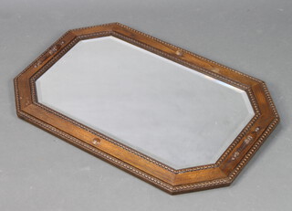 A 1930's lozenge bevelled plate wall mirror contained in a Japanese style oak frame 51cm x 80cm (silvering to mirror showing signs of deterioration) 