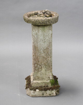 A well weathered circular garden bird bath raised on a square column 64cm h x 27cm (in 2 pieces) 