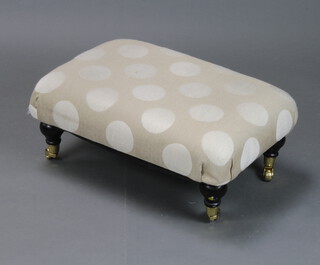 A Victorian style footstool upholstered in light coloured roundel pattern material 24cm h x 61cm w x 43cm d 