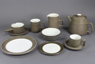 A quantity of Denby tableware comprising tea cups, coffee cups, saucers, casseroles, tea and coffee pots