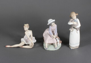 A Lladro figure of a young girl with a dog at her feet 16cm, a ditto of a ballerina 13cm and ditto young girl with a lamb 22cm  