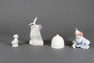 A Lladro figure of a poodle 9cm, ditto of a clown with ball 5278 13cm, a bell 8cm and shop display Lladro Society 18cm 