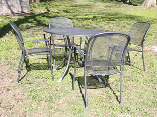 A circular tubular metal garden table raised on out swept supports 74cm h x 110cm diam. together with 4 stacking chairs
