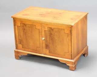 A Georgian style yew record cabinet enclosed by panelled doors on bracket feet 51cm h x 71cm w x 41cm d (some scratching to top and 1 brass knob missing to door)