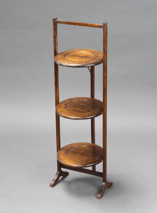 A 1930's oak circular 3 tier folding cake stand 85cm x 22cm  