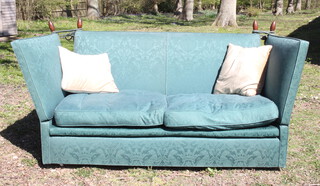 A Knowle style sofa upholstered in green material 