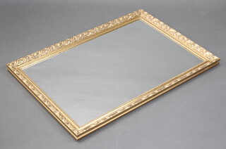 A rectangular plate wall mirror in a decorative gilt frame 88cm x 82cm 