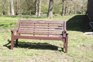 A slatted hardwood garden bench 88cm h x 153cm w x 64cm d 