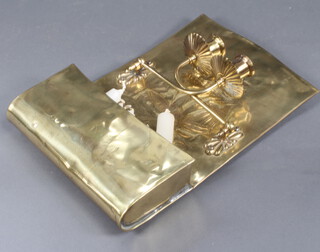A repousse brass wall light with hinged arms 
