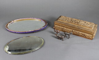 A Chinese carved hardwood rectangular box decorated with a village scene and minor decorative items
