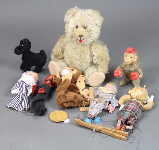 A mohair teddy with glass eyes and silk pads 38cm, a keywind monkey, ditto dog and 5 pupets 