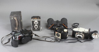 A pair of binoculars and various cameras 