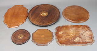 A circular Victorian inlaid rosewood table top 22cm together with a ditto circular undertier 26cm, a shaped Edwardian inlaid mahogany wine table top 30cm, circular wine table top 43cm and 2 others (all have contact marks, some water marks) 
