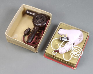 A vintage brown Bakelite hair dryer and a Pifco hair dryer 