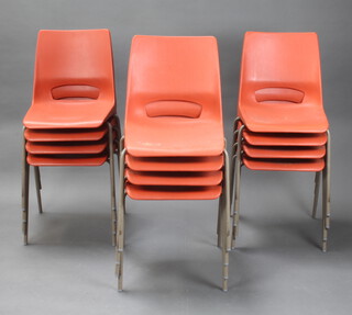 A set of 12 light red stackable chairs by Phillipus Potter