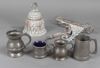 A cast brass bell, 4 pewter vessels and a Victorian rattle 
