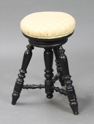 A Victorian ebonised 3 legged revolving adjustable piano stool 50cm h x 32cm diam.  