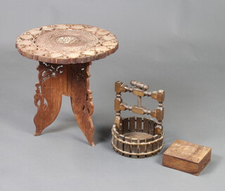A circular Moorish style carved and pierced hardwood folding table 40cm x 38cm diam. a carved oak circular nut cracker 26cm x 20cm and a carved hardwood box 6cm x 14cm x 13cm  