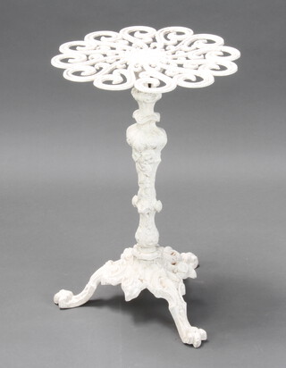 A Victorian style circular white painted pierced aluminium garden table raised on rococo style supports 68cm x 44cm 
