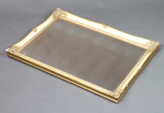 A rectangular bevelled plate tinted wall mirror contained in a cream and gilt frame 75cm x 49cm 
