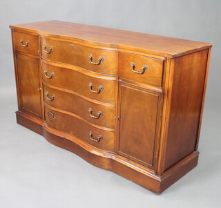 Bassett Furniture, a Philadelphia style mahogany sideboard of serpentine outline fitted 4 long drawers flanked by cupboards 86cm h x 155cm w x 51cm d, (some contact marks to the top)

