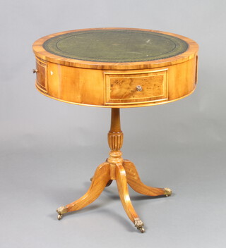 A circular Georgian style yew drum table fitted with inset leather writing surface and 2 frieze drawers, raised on a pillar and tripod base 67cm h x 52cm diam. (slight scuffing to the top) 