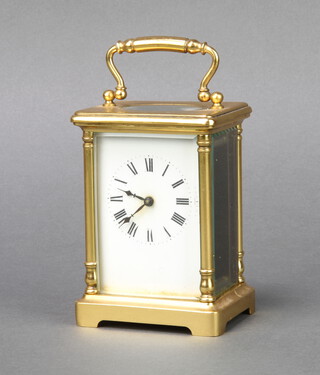 A 19th Century French 8 day carriage timepiece with enamelled dial and Roman numerals contained in a gilt metal case raised on bracket feet 12cm h x 8cm x 6.5cm d 