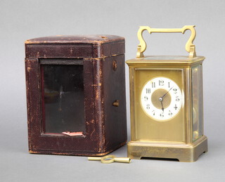 A 19th/20th Century French 8 day carriage clock, striking on a gong, with circular porcelain dial and Arabic numerals contained in a gilt metal case, complete with key and leather case 13cm h x 9cm w x 8.5cm d  