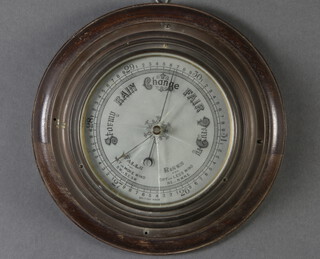 An aneroid barometer with silvered dial, contained in a gilt metal case 4cm x 27cm diam. 