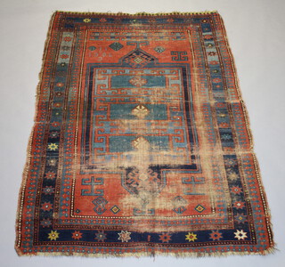 A blue and tan ground Caucasian rug, the centre medallion with a multi row border, 203cm x 139cm  
