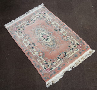 A peach ground and floral patterned Chinese rug with central medallion 189cm x 126cm 